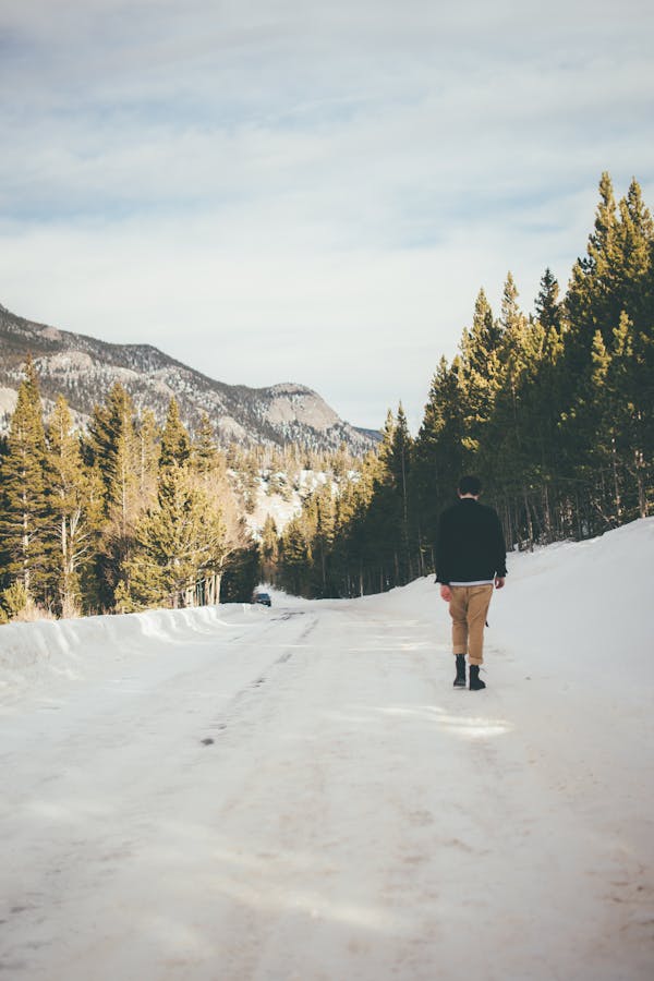 man walking on an icy road