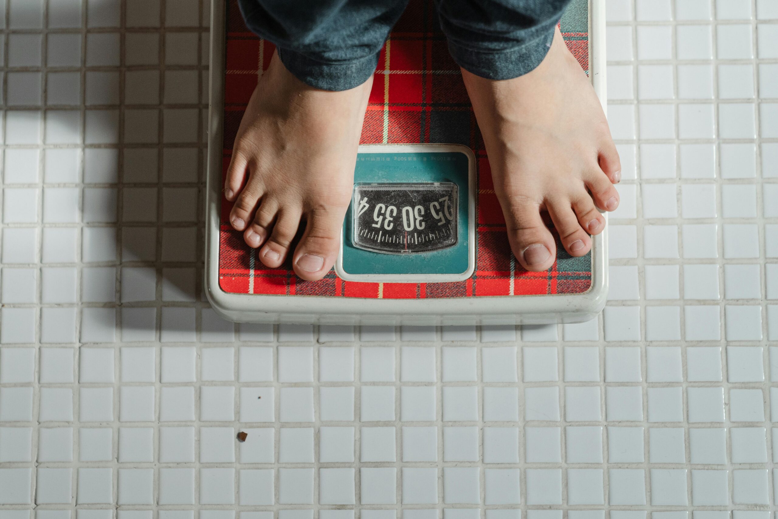 a guy on a weighing scale