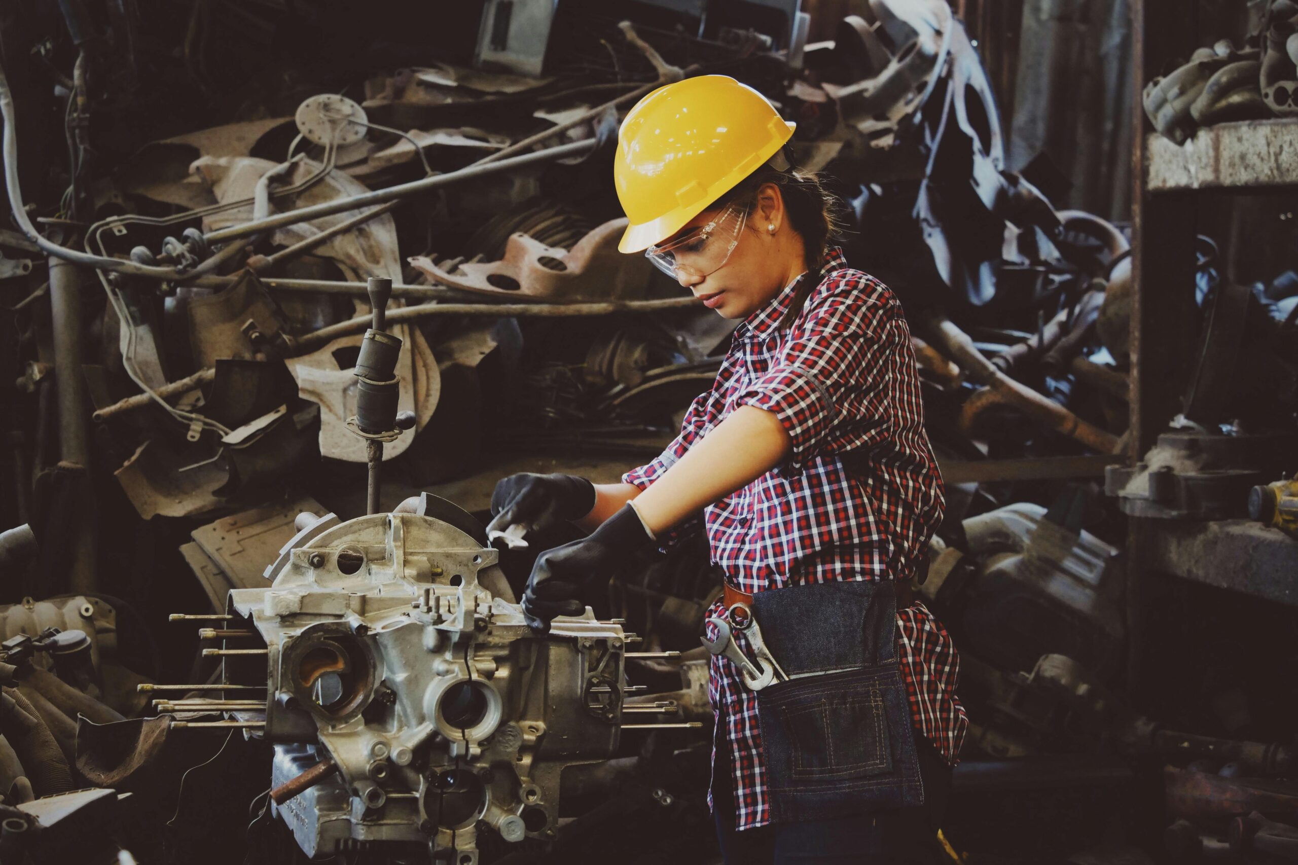 a woman fixing an engine