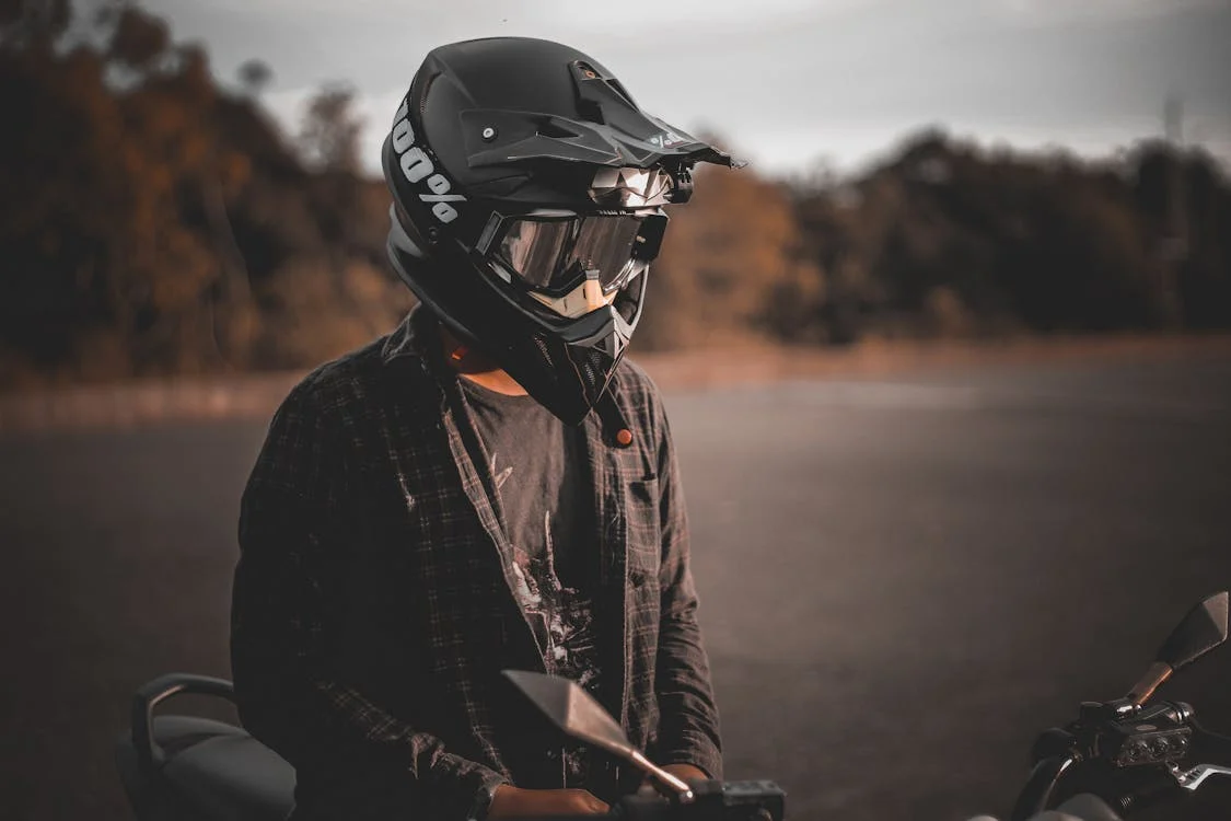 a man on a motorcycle wearing a helmet