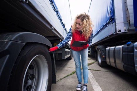 person checking truck tyre