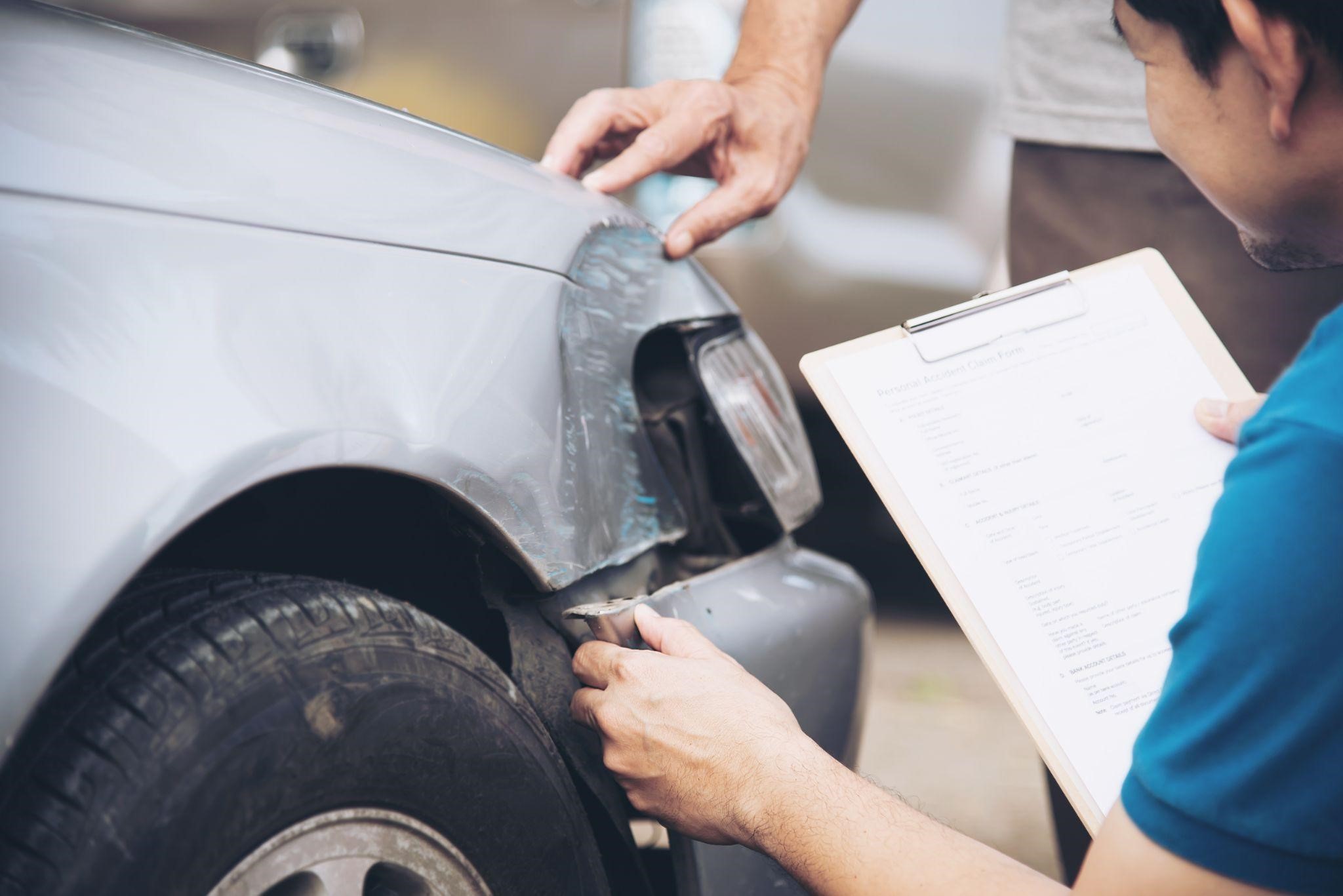 a person checking the damage of the car