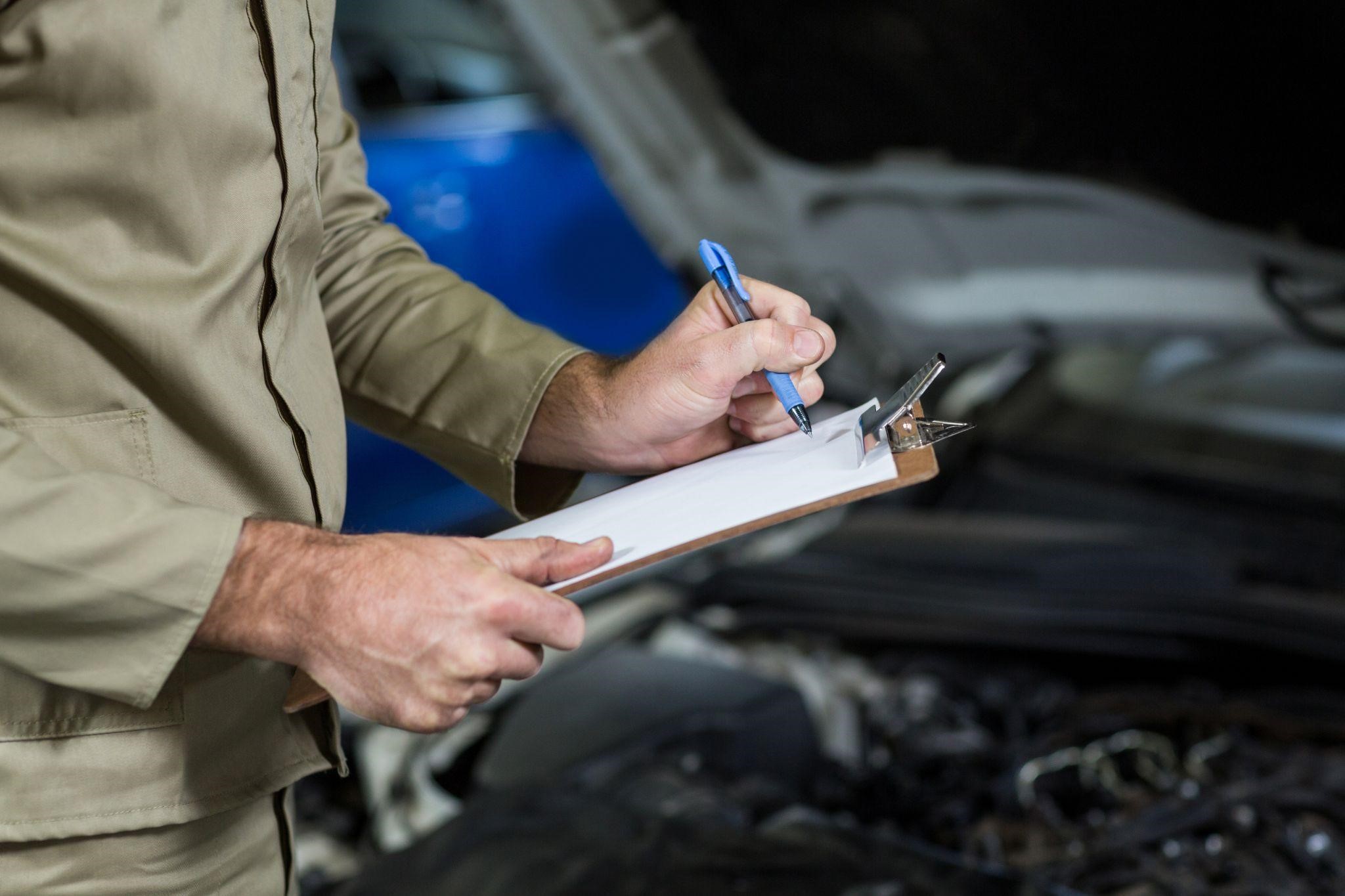 a person inspecting a car